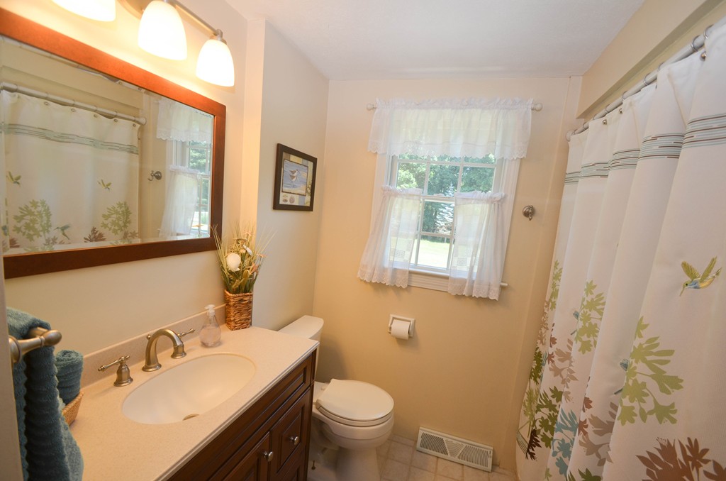 18 Baldpate Road Georgetown, MA 01833 - Photo 14 of 19 a bathroom with a sink toilet and a mirror