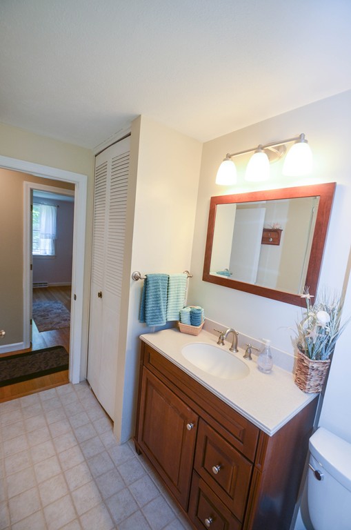 18 Baldpate Road Georgetown, MA 01833 - Photo 15 of 19 a bathroom with a sink vanity and a mirror