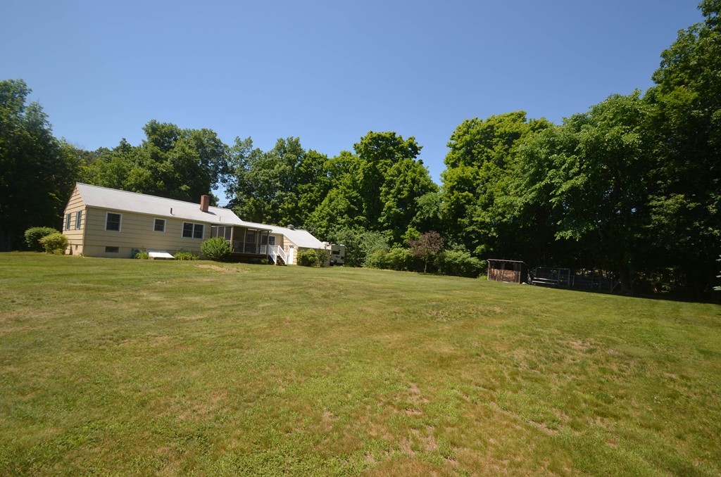 18 Baldpate Road Georgetown, MA 01833 - Photo 3 of 19 a white house with a big yard plants and large trees