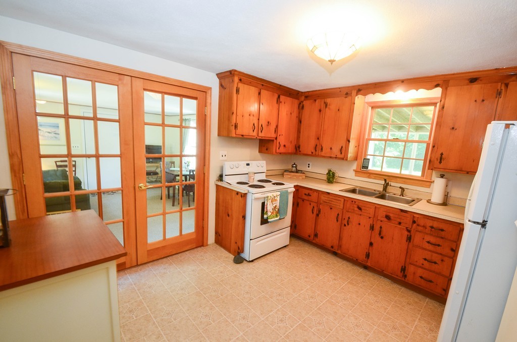18 Baldpate Road Georgetown, MA 01833 - Photo 8 of 19 a kitchen with stainless steel appliances granite countertop a stove a sink and a refrigerator