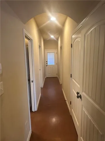 a view of a hallway with wooden shelves
