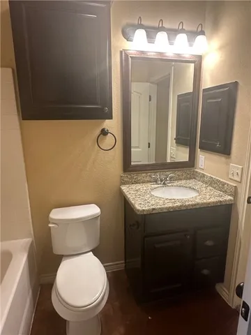 a view of bathroom with a toilet sink and mirror
