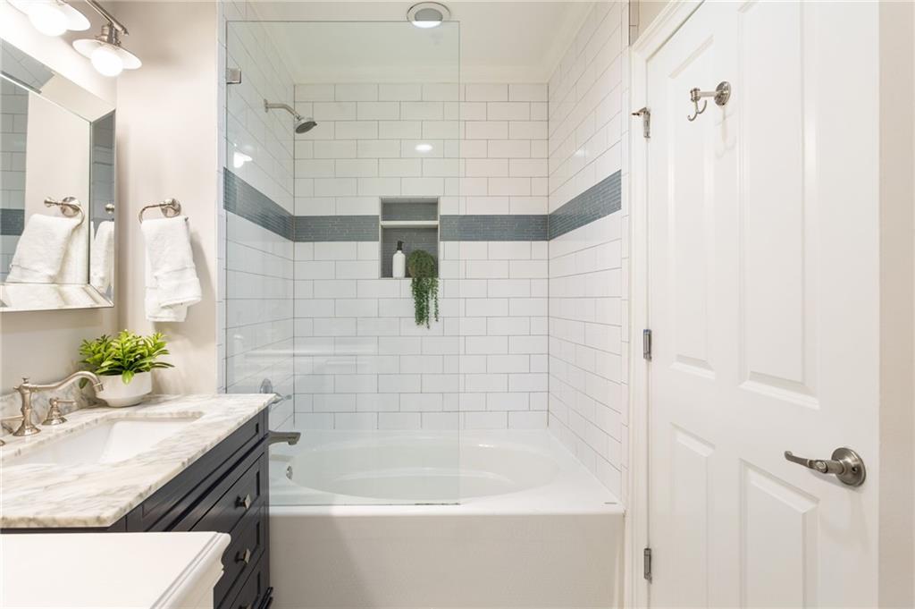 2255 Peachtree Road Northeast, Unit 326 Atlanta, GA 30309 - Photo 2 of 37 a bathroom with a granite countertop sink a toilet and bathtub
