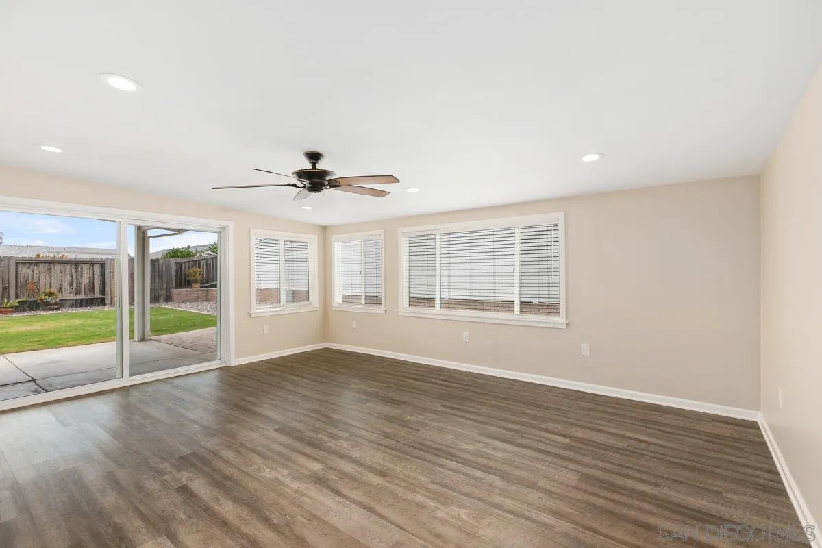 10025 Pinewood View Santee, CA 92071 - Photo 12 of 29 a view of an empty room with wooden floor and a window