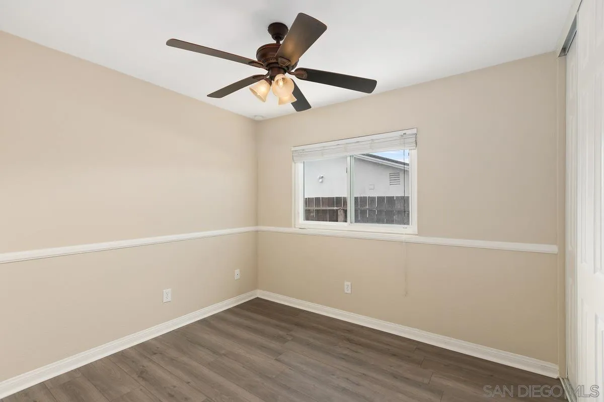 10025 Pinewood View Santee, CA 92071 - Photo 16 of 29 a view of an empty room with wooden floor and a window