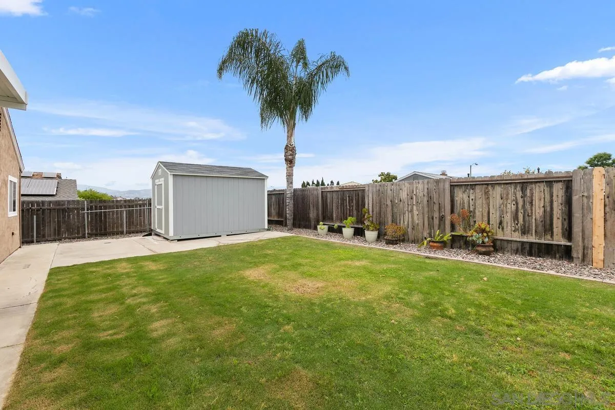 10025 Pinewood View Santee, CA 92071 - Photo 21 of 29 a view of a backyard with a garden and palm trees