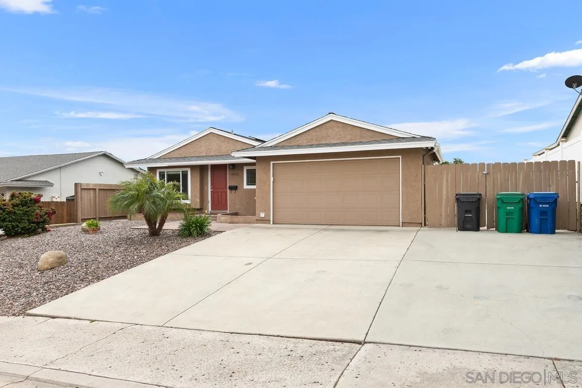 10025 Pinewood View Santee, CA 92071 - Photo 3 of 29 a front view of a house with a yard and garage