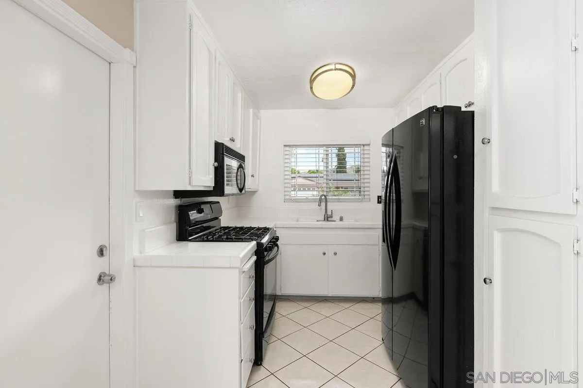 10025 Pinewood View Santee, CA 92071 - Photo 9 of 29 a kitchen with a refrigerator sink and stove