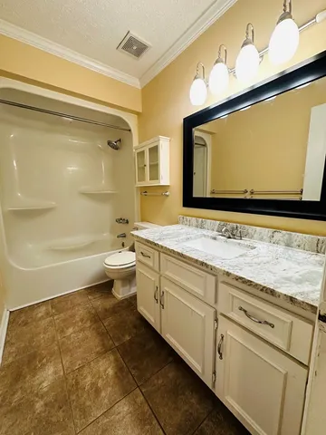a bathroom with a sink a mirror and a toilet