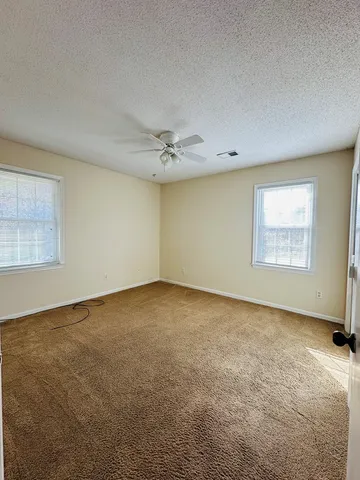 an empty room with a empty space and windows