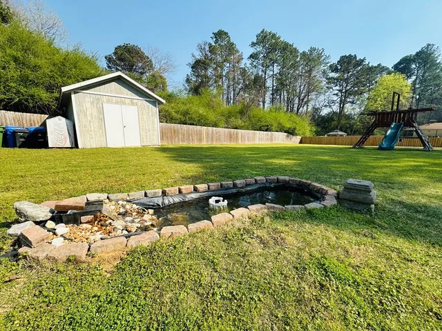 a view of a house with a yard and swimming pool