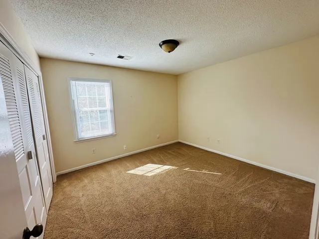 an empty room with a empty space and a window