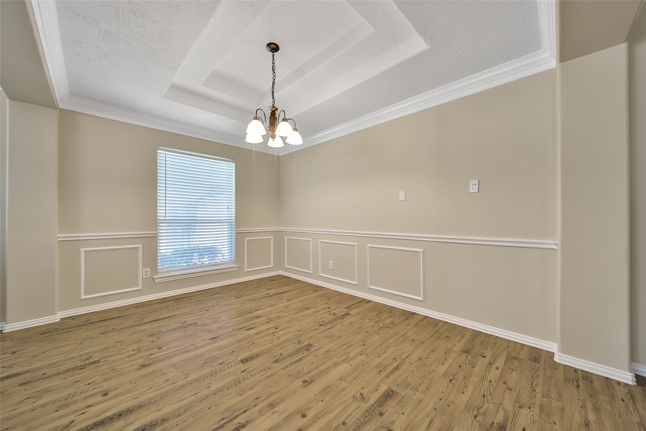 21338 Timber Pines Drive Spring, TX 77388 - Photo 8 of 29 a view of an empty room with wooden floor and a window