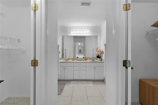 a bathroom with a granite countertop sink a mirror and shower