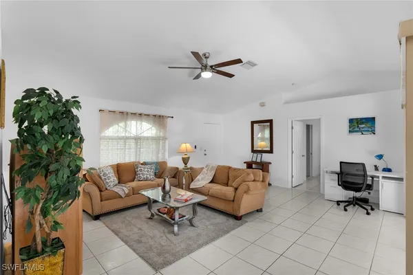 a living room with furniture and a lamp