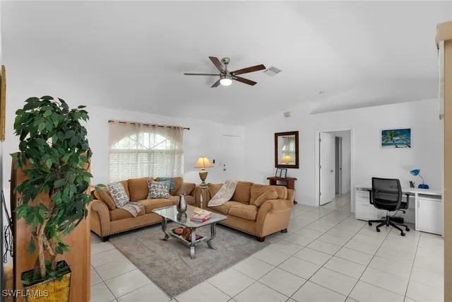 a living room with furniture and a lamp