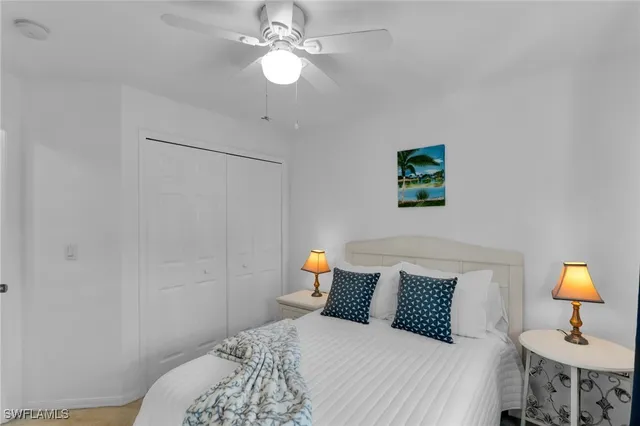 a bedroom with a bed and a lamp on dresser