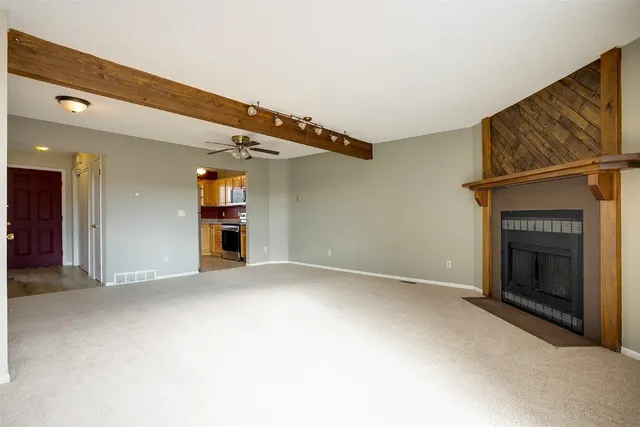 a view of an empty room with a fireplace