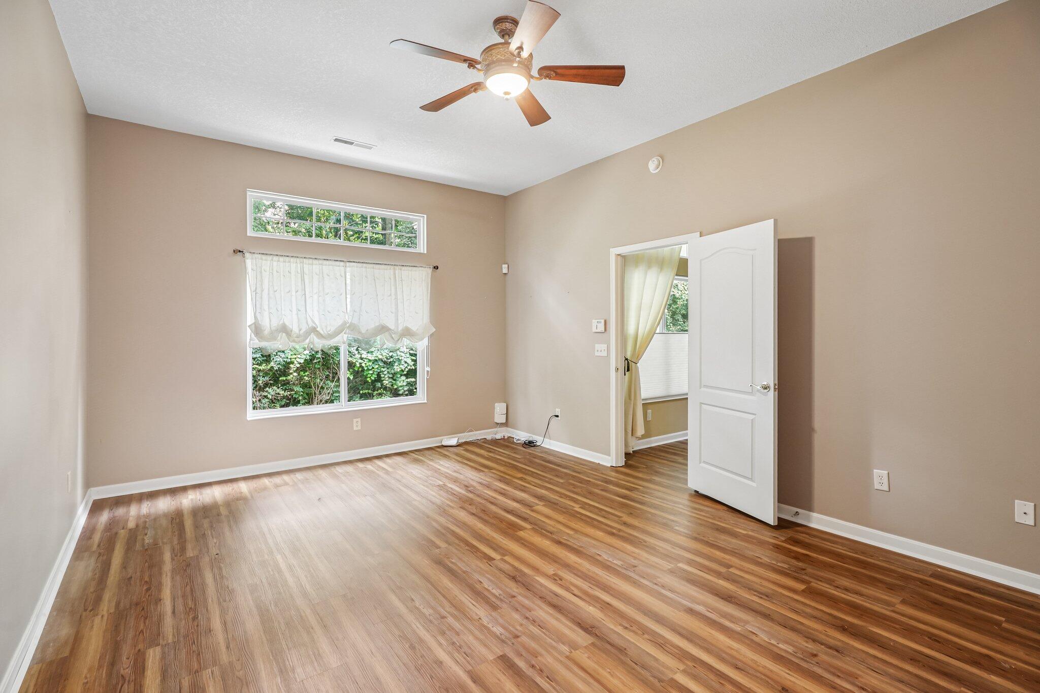 876 Flint Ridge Newport, KY 41076 - Photo 25 of 43 Spacious room featuring vaulted ceilings, wood-finish flooring, a ceiling fan, and large windows with a transom above