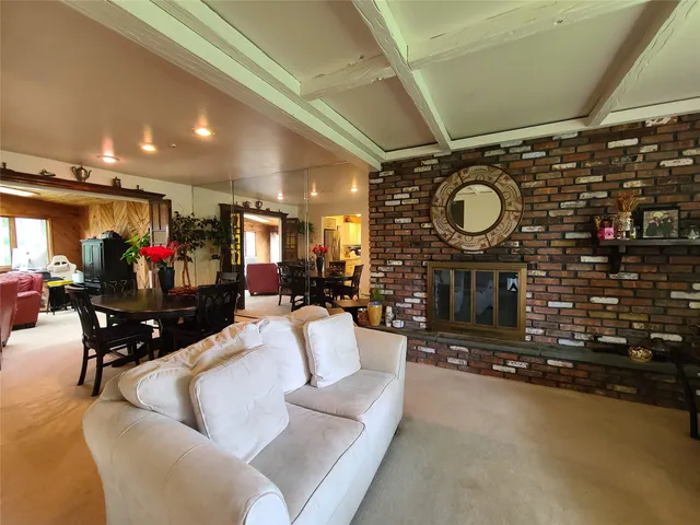 a living room with fireplace furniture and a fireplace