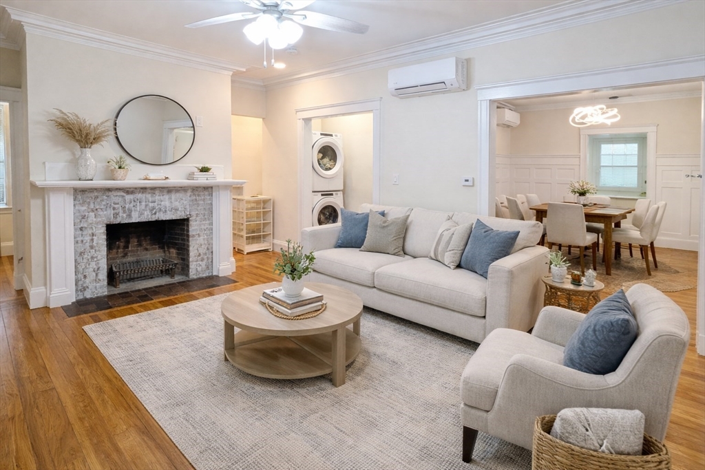446 Lowell Avenue, Unit 446 Newton, MA 02460 - Photo 1 of 15 a living room with furniture and a fireplace