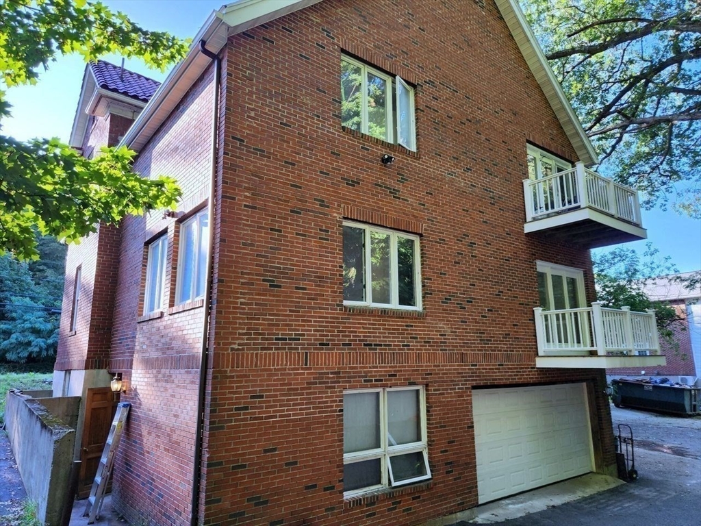 446 Lowell Avenue, Unit 446 Newton, MA 02460 - Photo 14 of 15 a front view of a house with a yard