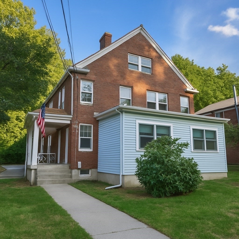 446 Lowell Avenue, Unit 446 Newton, MA 02460 - Photo 2 of 15 a front view of a house with a yard