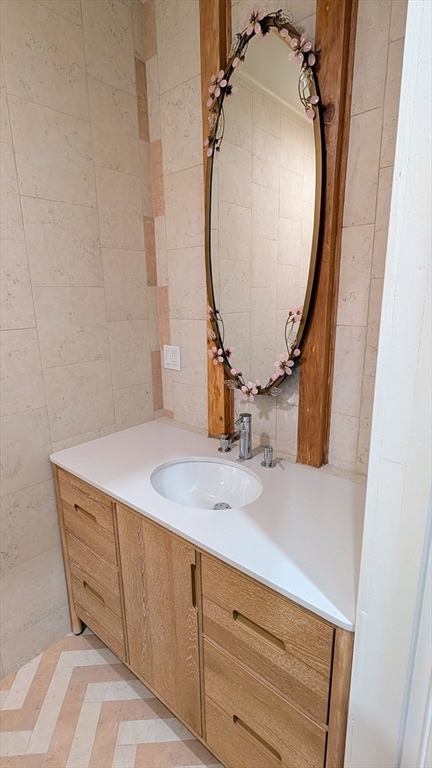 446 Lowell Avenue, Unit 446 Newton, MA 02460 - Photo 7 of 15 a bathroom with a sink vanity and a mirror
