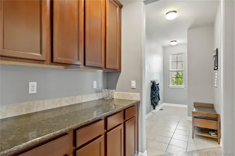 a kitchen with granite countertop a sink and cabinets