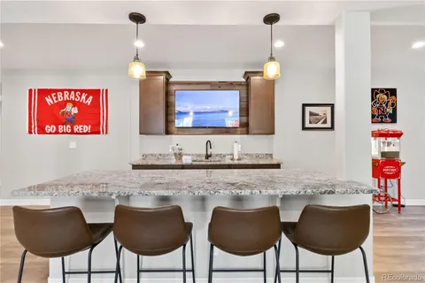 a kitchen with stainless steel appliances granite countertop a sink and a refrigerator