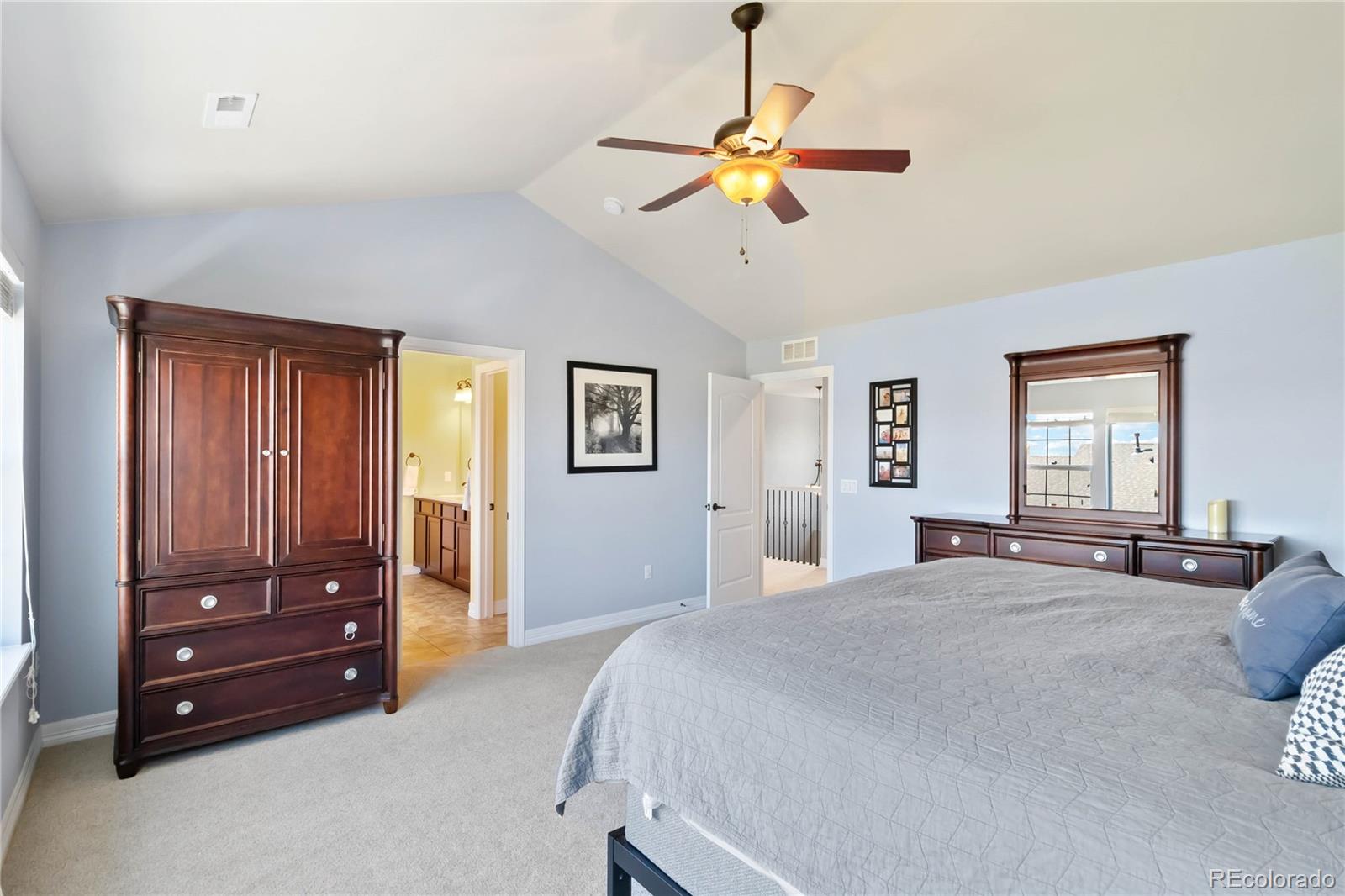 3034 Mashie Circle Castle Rock, CO 80109 - Photo 24 of 50 a bedroom with a bed and a chandelier