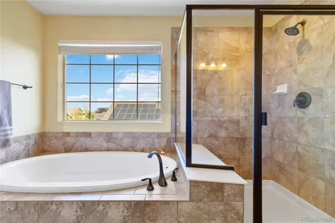 a bathroom with a bathtub and shower