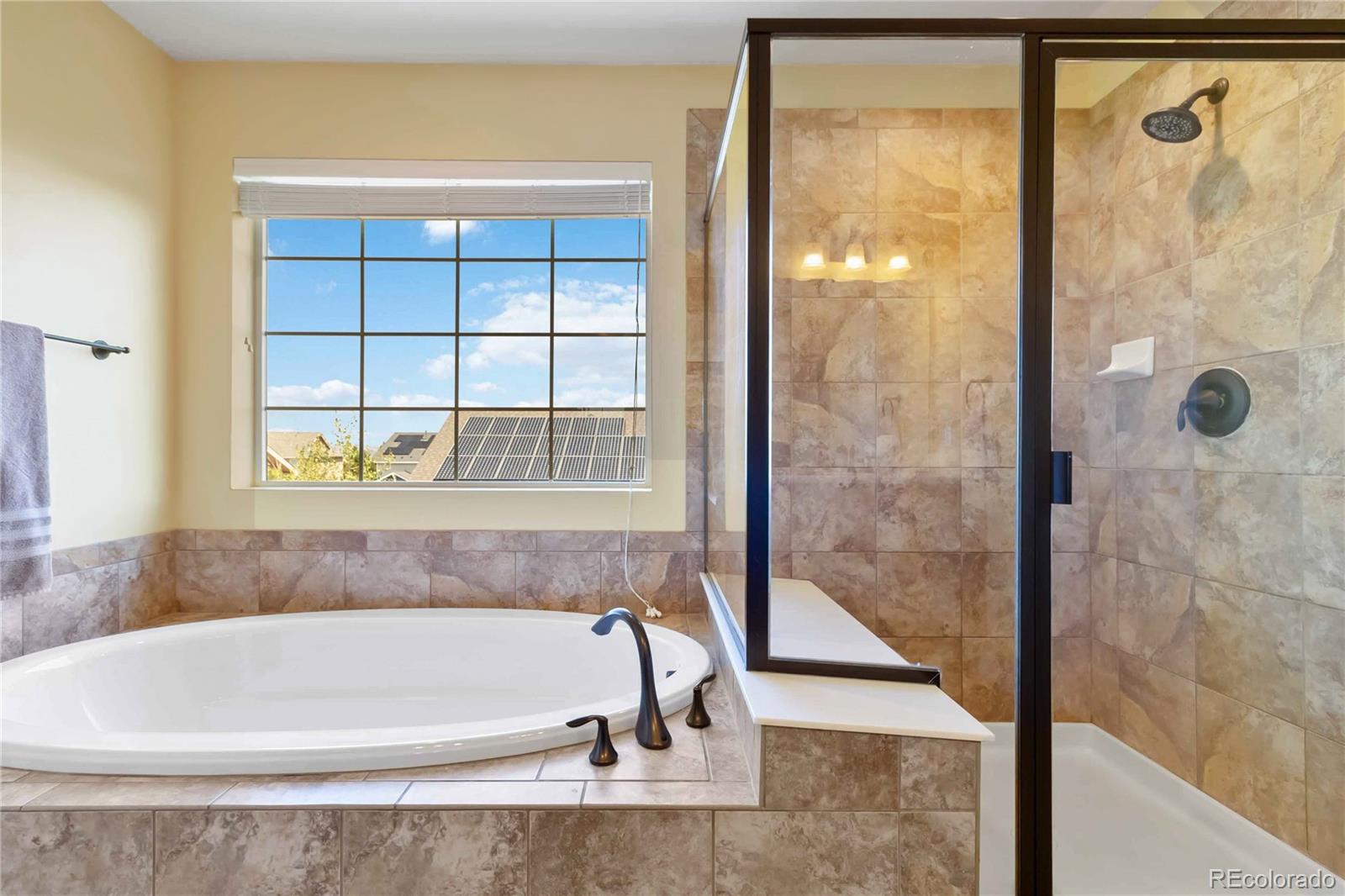 3034 Mashie Circle Castle Rock, CO 80109 - Photo 25 of 50 a bathroom with a bathtub and shower