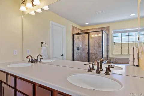 a bathroom with a sink double vanity and a mirror