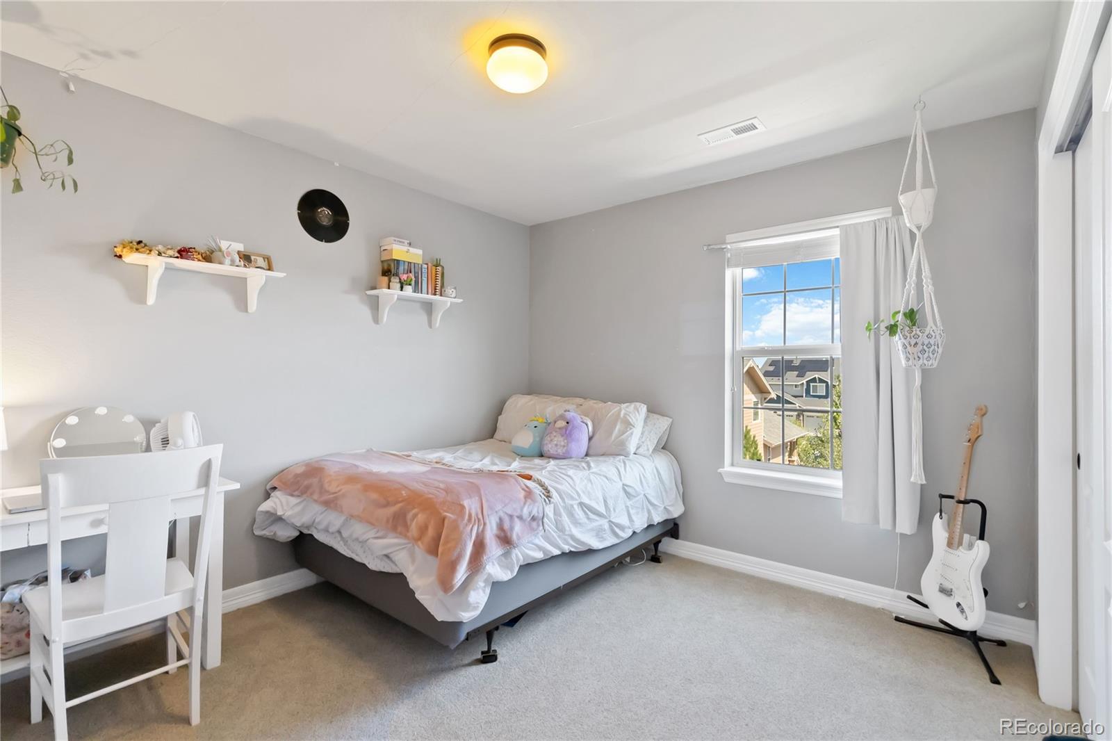 3034 Mashie Circle Castle Rock, CO 80109 - Photo 27 of 50 a bedroom with a bed and a window