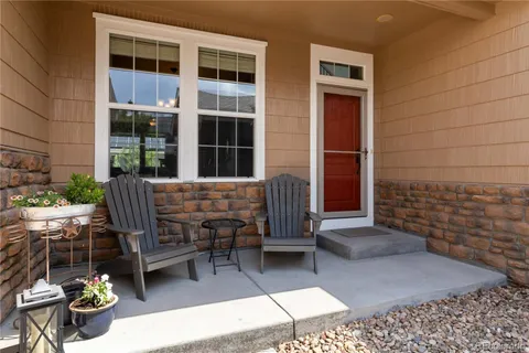 a view of a patio with table and chairs and wooden fence