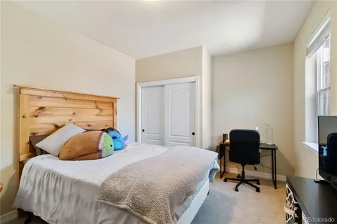 a bedroom with a bed and a chair