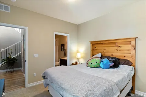 a bedroom with a large bed and a chandelier