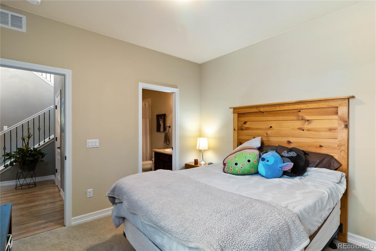 3034 Mashie Circle Castle Rock, CO 80109 - Photo 33 of 50 a bedroom with a large bed and a chandelier