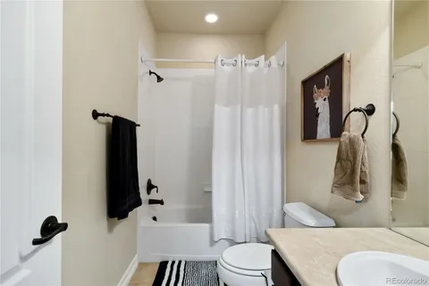 a bathroom with a toilet sink and shower