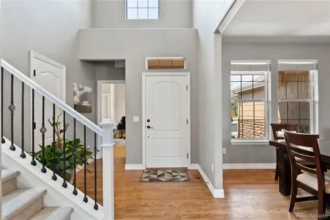 a view of a hallway with wooden floor and entryway