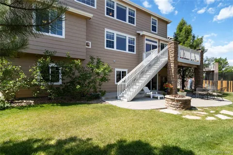 a view of a house with backyard and sitting area