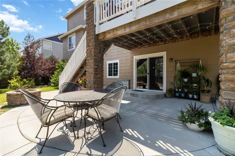 a view of a house with backyard and sitting area