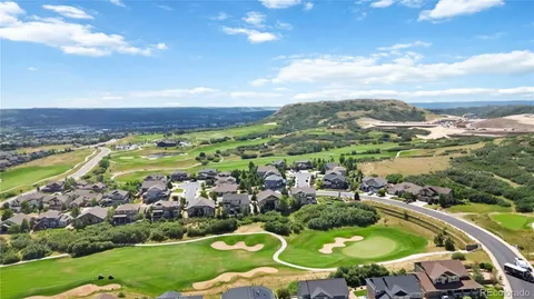 an aerial view of residential houses with outdoor space and river