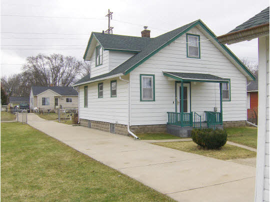 520 Brooke Road Rockford, IL 61109 - Photo 2 of 9 a view of a white house next to a yard with potted plants
