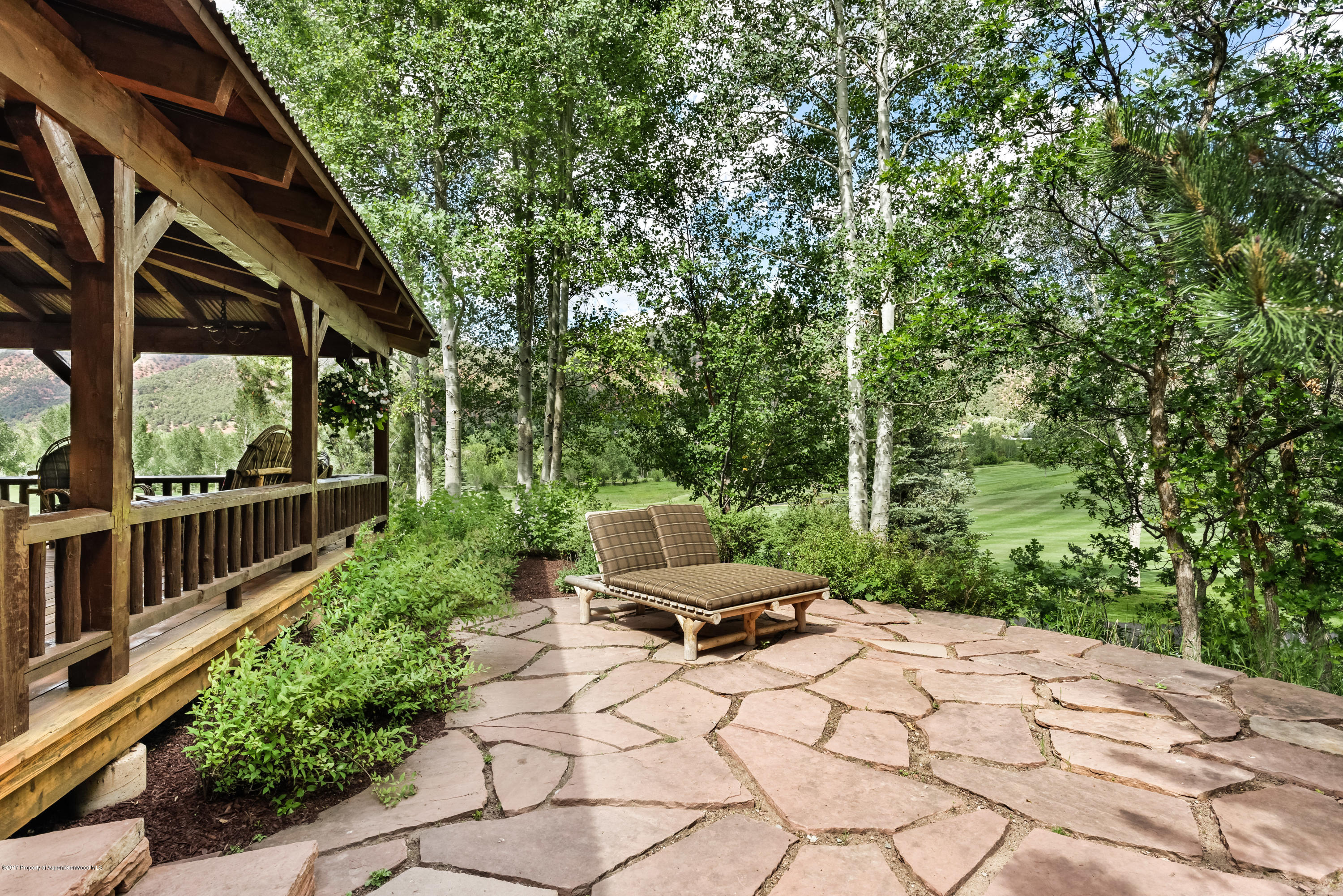 39 Altamira Ranch Road, Unit CABIN 39 Basalt, CO 81621 - Photo 20 of 23 a view of a chair and tables in the backyard of a house