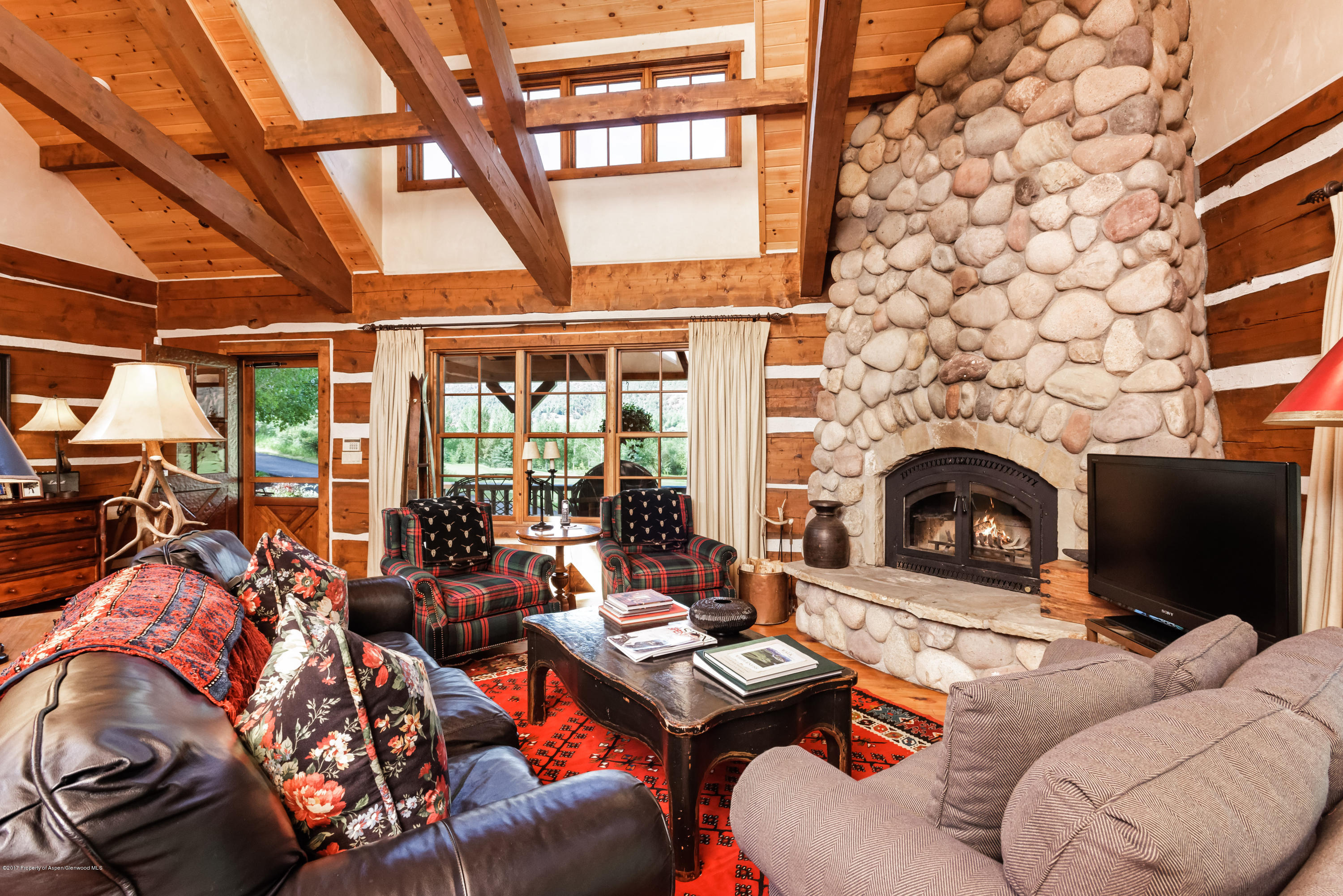 39 Altamira Ranch Road, Unit CABIN 39 Basalt, CO 81621 - Photo 3 of 23 a living room with furniture a fireplace and a table