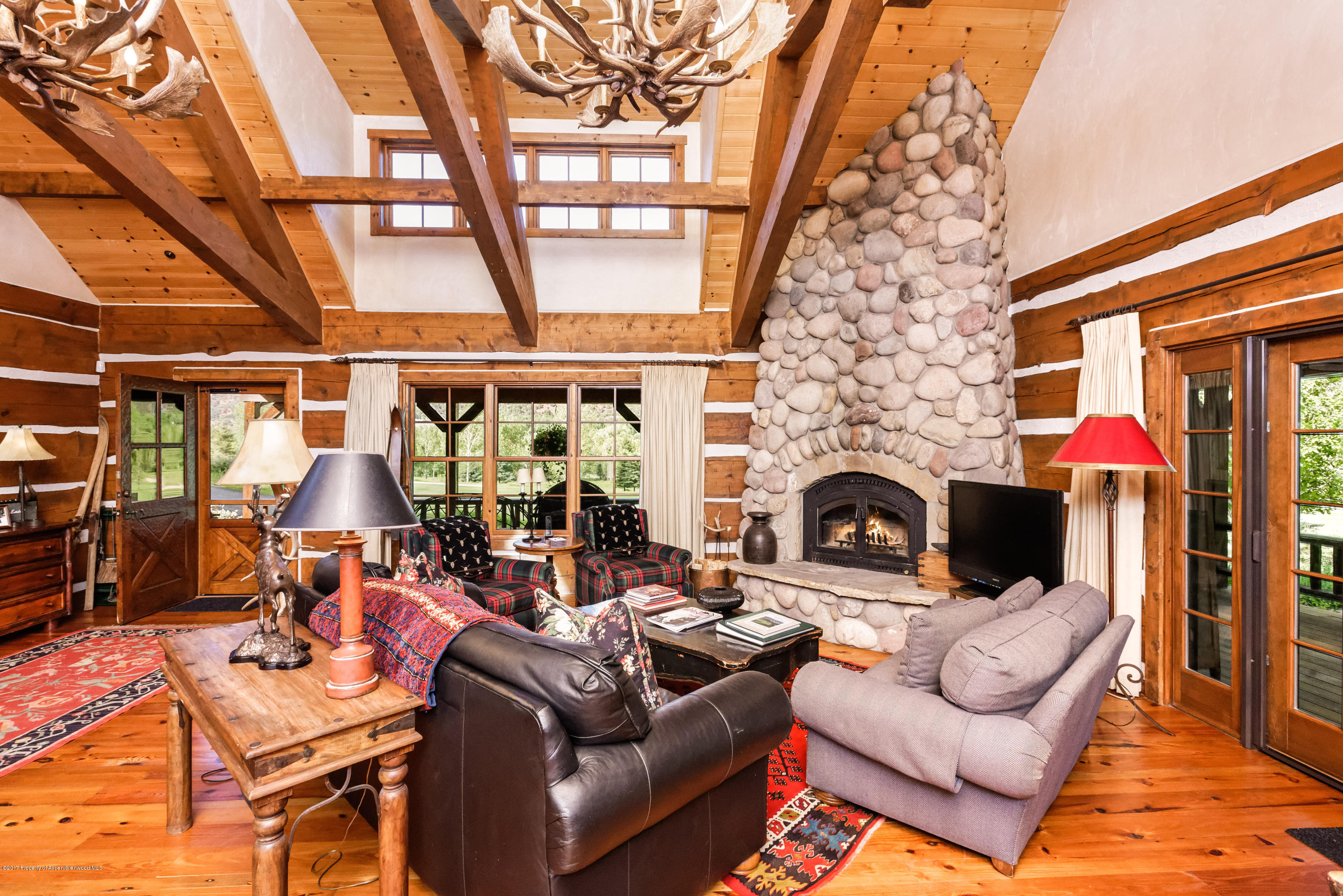 39 Altamira Ranch Road, Unit CABIN 39 Basalt, CO 81621 - Photo 5 of 23 a living room with furniture a fireplace and a flat screen tv