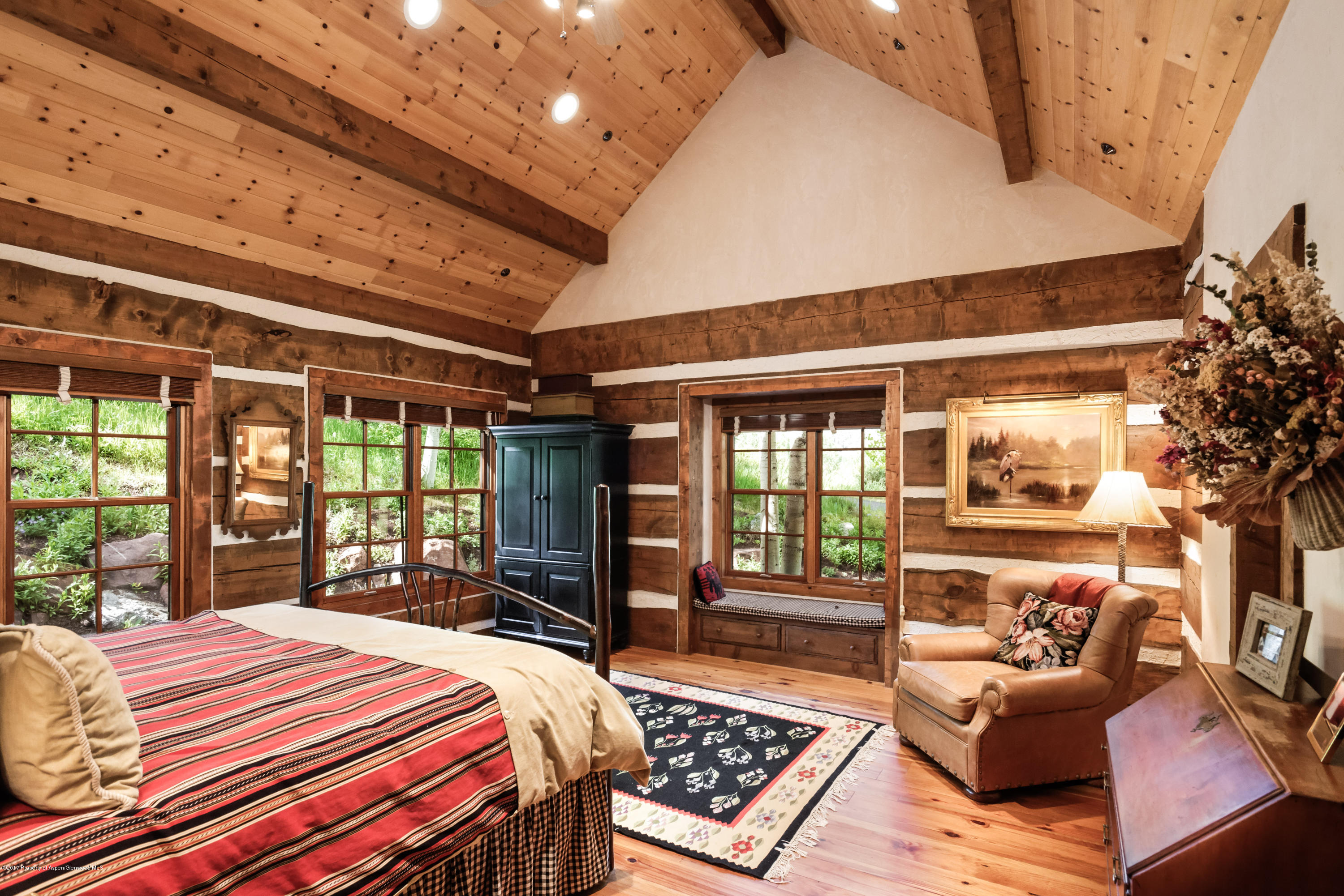 39 Altamira Ranch Road, Unit CABIN 39 Basalt, CO 81621 - Photo 8 of 23 a bedroom with a bed wooden floor and a large window