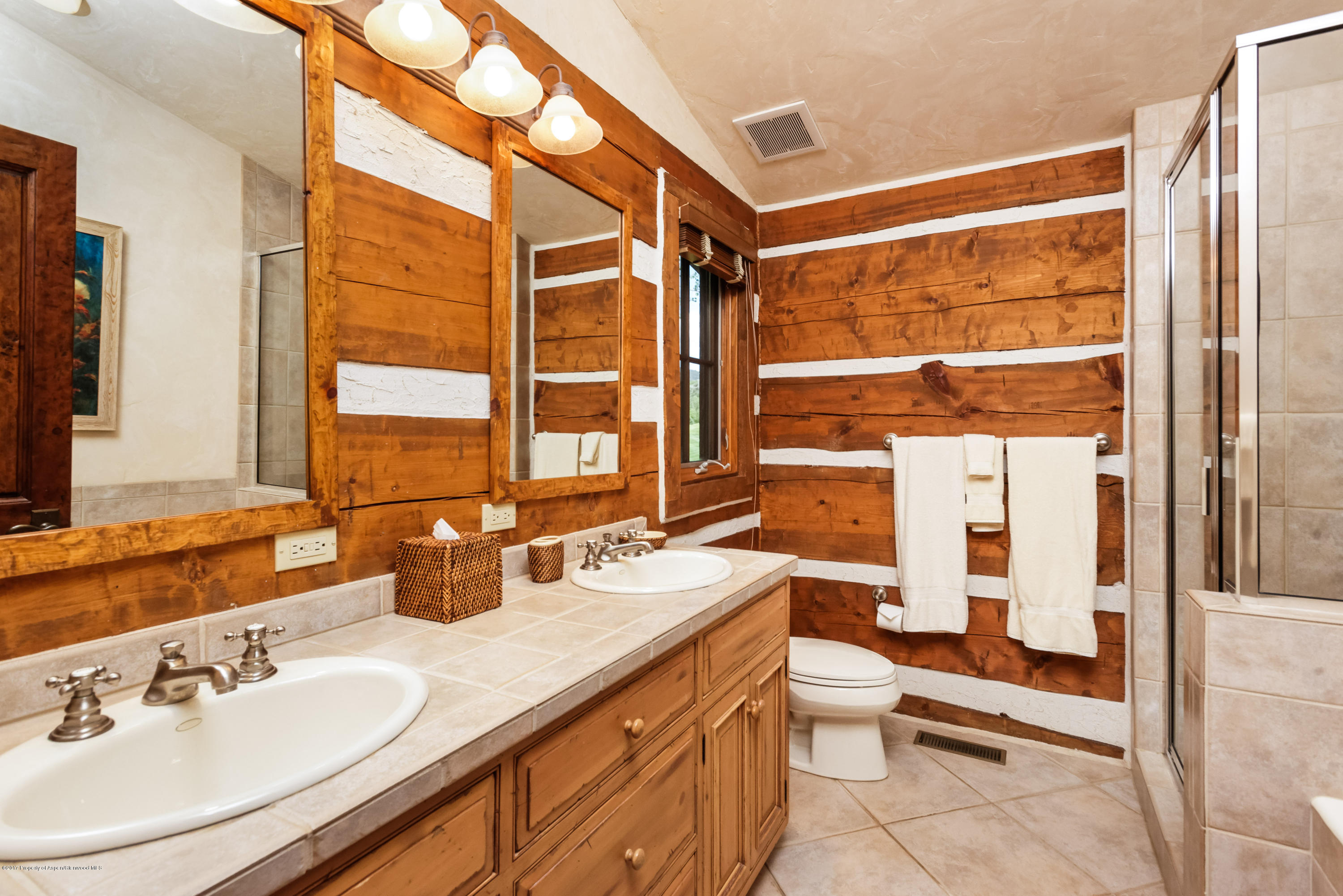 39 Altamira Ranch Road, Unit CABIN 39 Basalt, CO 81621 - Photo 9 of 23 a spacious bathroom with a double vanity sink toilet and a tub